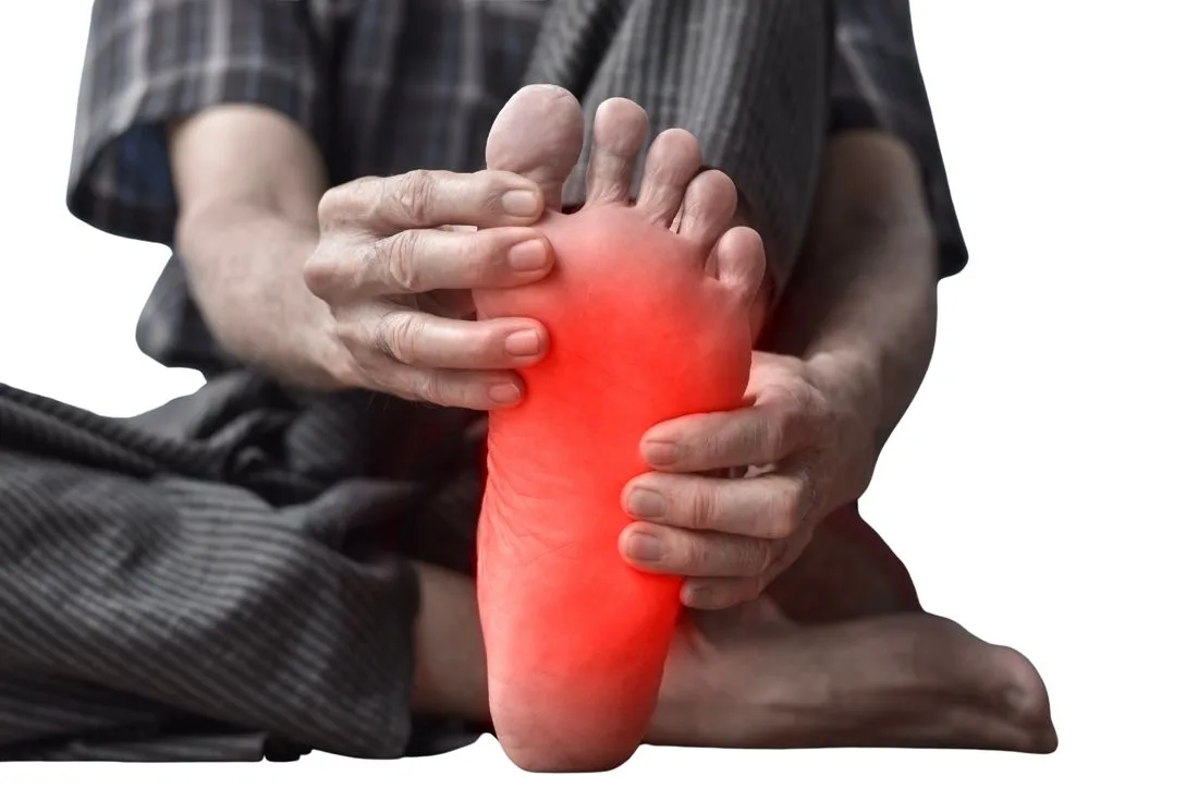 Person holding a painful foot