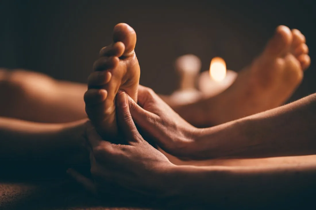 Relaxing foot reflexology massage by candlelight