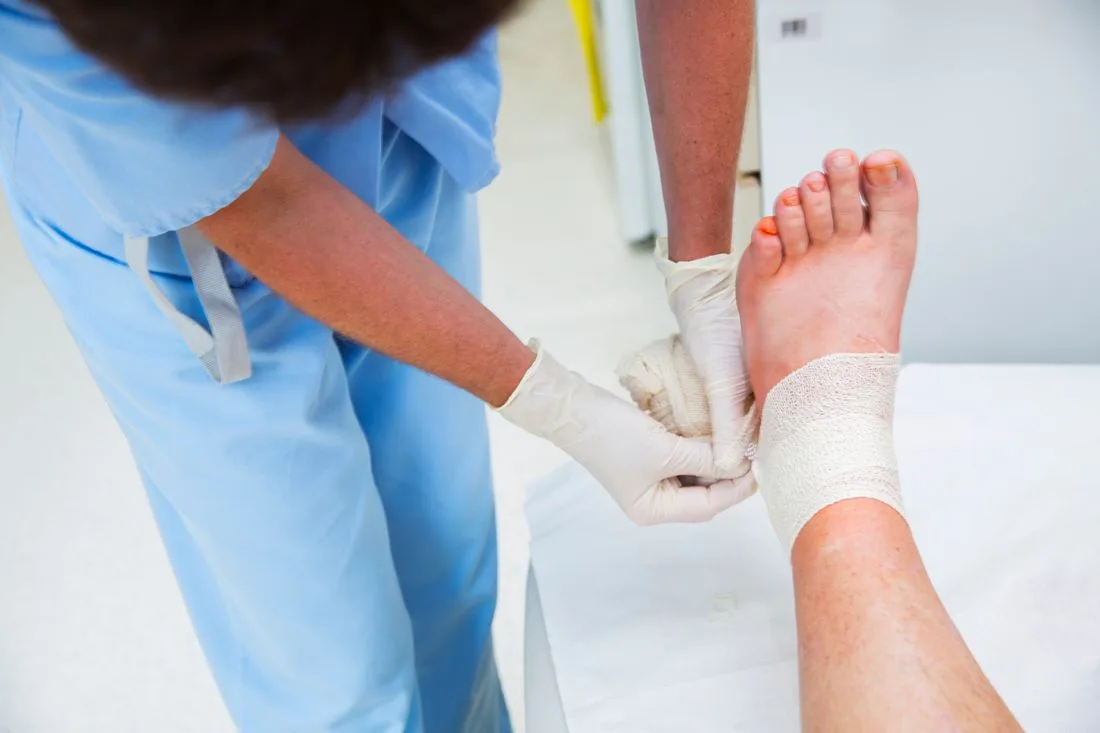 Nurse applying a dressing to a client's foot